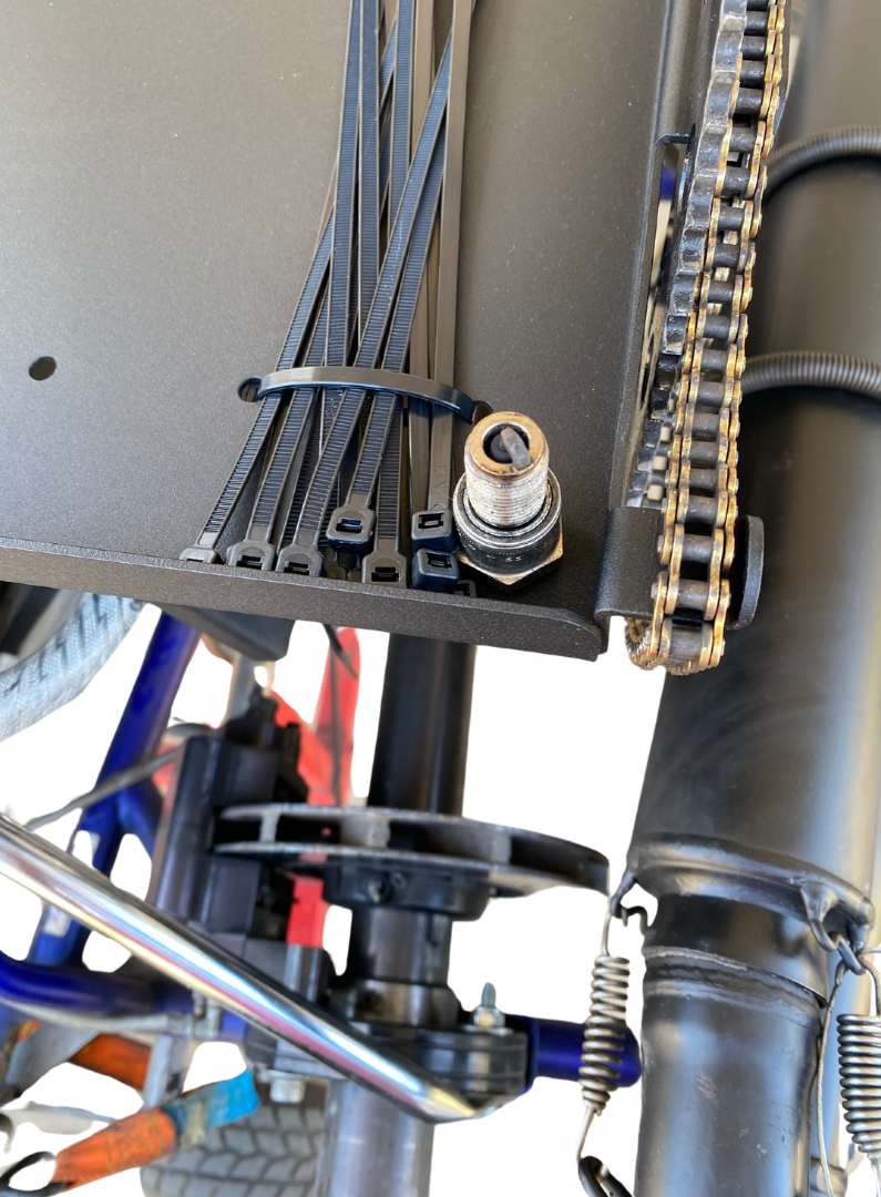 spark plug resting in kart mounted workshop for go karts